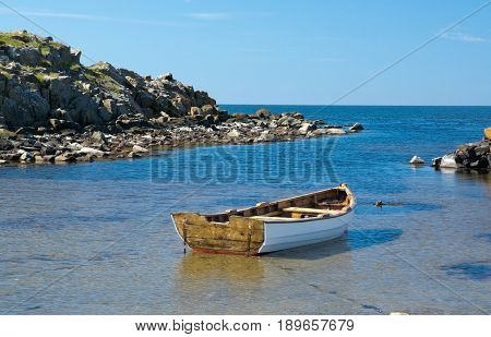 Boat moored in a tranquil bay in Halland Sweden in June.