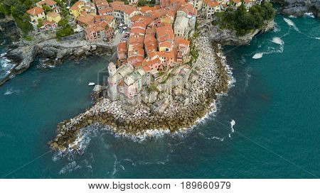 Aerial video shooting with drone on Tellaro, famous Ligurian village near the Cinqueterre, small colored houses built on the cliff by the sea