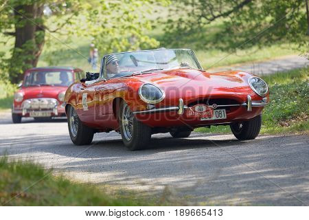 STOCKHOLM SWEDEN - MAY 22 2017: Red Jaguar E-Type classic car in a in the public race Gardesloppet in the beautiful forests in Djurgarden in Stockholm. May 22 2017 in Stockholm Sweden