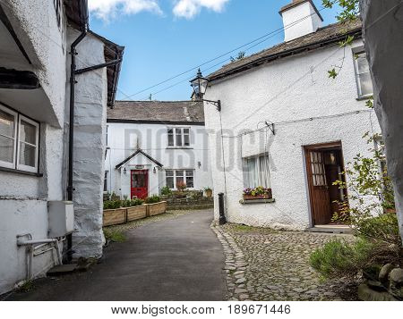 HAWKSHEAD UK - 23 APRIL 2017: The crowded whitewashed architecture of the village of Hawkshead in the heart of the English Lake District.