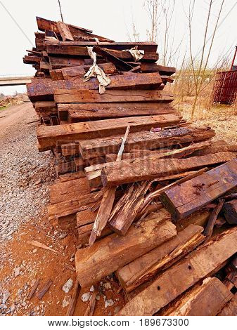 Terrible Smell Pile Of Extracted Old Wooden Ties. Old Oiled Used Oak Railway Sleepers Stored