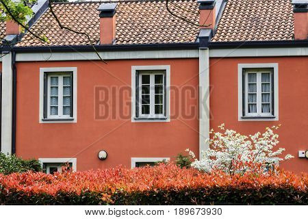 Red facade of building along the bicycle path of the Lambro valley (Monza Brianza Lombardy Italy) at spring