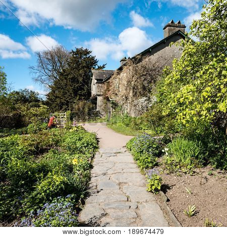 NEAR SAWREY UK - 23 APRIL 2017: The quaint English country cottage known as Hill Top in the Lake District village of Near Sawrey. The house was once the home of children's author Beatrix Potter.