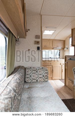 Inside A Caravan Showing Seats And Kitchen Area