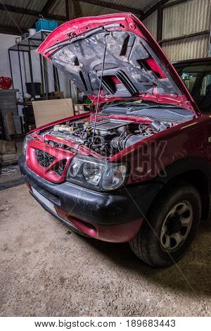 Vertical Shot Of Car In Garage With Bonnet Up