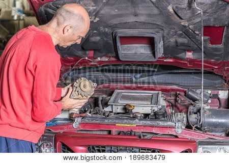 Mechanic Working On A Car Engine