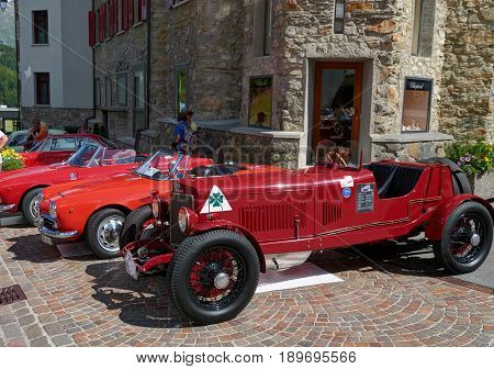 Saint Moritz Switzerland AUG 20 2010: View on navy and red color classic old fashion style classical Alfa Romeo cars at street exhibition. Italian classic cars. Luxury and style. Swiss Matterhorn