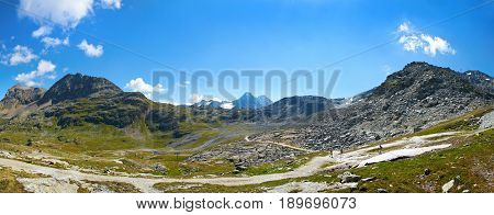 Beautiful panoramic view on Swiss Alps, Alpine green mountains hills, walking tourists, amazing blue sky clouds. Touristic ways paths to sightseeing viewpoint. Swiss holidays vacations. Corvatsch