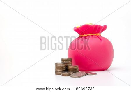 Piggy bank or money bag shaped money box with coins on white background in saving money concept copy space
