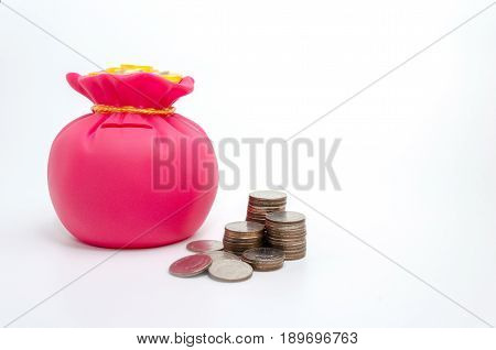 Piggy bank or money bag shaped money box with coins on white background in saving money concept copy space