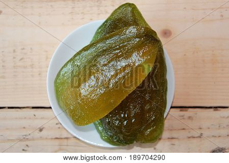 Cedrat on a white plate with a wooden spoon