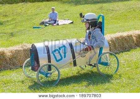 STOCKHOLM SWEDEN - MAY 21 2017: Boy driving a home made soapbox car downhill on a field in the race Gardesloppet at Djurgarden Stockholm Sweden. May 21 2017