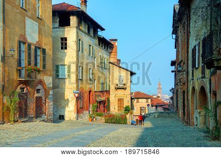 Colorful classical Italian old fashion antique houses buildings architecture in Saluzzo. Italian painting ornaments architectural elements jalousie. Italian architecture. Italy holidays vacation tours