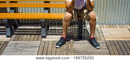 Sitting on the bench with headphone cord