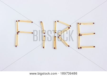 The inscription from the matches is fire. The word is laid out of wooden matches.