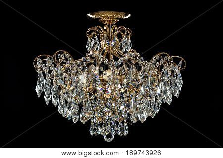 Large crystal chandelier isolated on black background. Luxury royal expensive chandelier for living room, Hall of celebration.