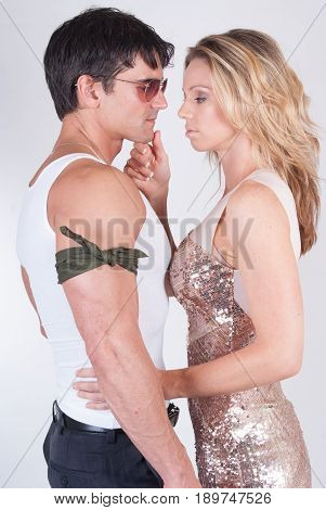 The mystery man is about to kiss a pretty lady.