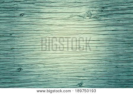 Wooden board planks fence with lines kinks curves texture background rough surface tender green yellow lime color copyspace for text