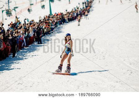 Sheregesh, Kemerovo region, Russia - April 16, 2016: Grelka Fest is a sports and entertainment activity for ski and snowboard riders in bikini.girl bikini swimsuit on a snowboard