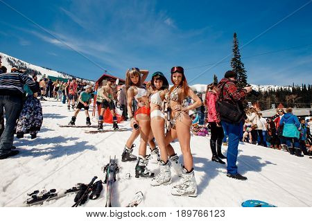 Sheregesh, Kemerovo region, Russia - April 16, 2016: Grelka Fest is a sports and entertainment activity for ski and snowboard riders in bikini.group of snowboarders friends in swimsuits.