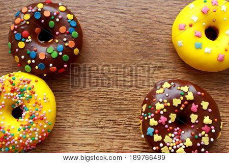 Four donuts composition on a wood background