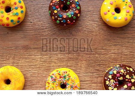 Six donuts composition on a wood background