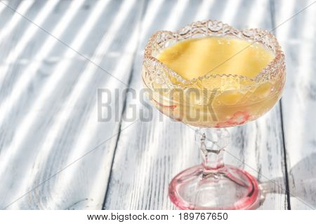 Glass vase of sabayon on the wooden background