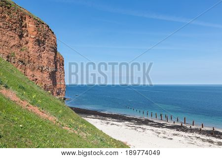 Red cliffs and beach at Helgoland island Germany
