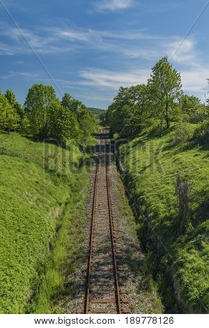 Old railway track in spring sunny day near Libouchec village