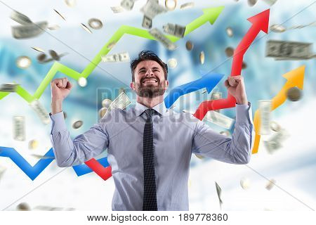 Happy businessman exults under a rain of coins and banknotes