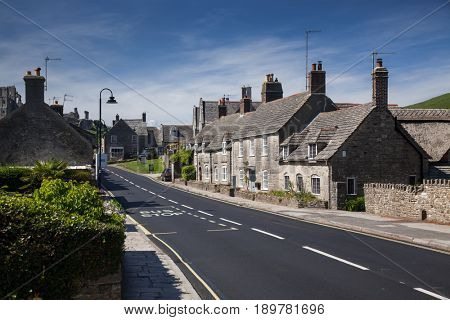 CORFE CASTLE, UK - 1st JUNE, 2017: Village of Corfe and ruins of Corfe Castle, in Swanage, Dorset, Southern England 