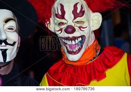 Quito, Ecuador - December 31, 2016: An unidentified people dreessed with differents ways of clothes and mask, celebrating new years gathering in city streets.