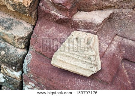 Abandoned Broken Buddha Image Amulet Left Outside Ruined Sandstone Pagoda In Temple, Northeastern Th