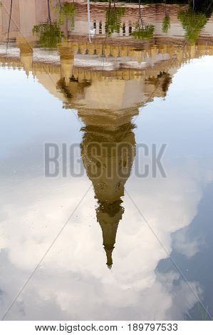 Reflection On Water Of Chedi Maha Mongkol Bua, The Golden Pagoda Landmark Of Roi Et Province, Northe