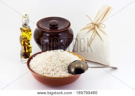 The Composition Of Rice Groats In A Clay Pial Next To A Clay Pot And A Copper Spoon,
