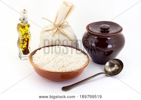 The Composition Of Rice Groats In A Clay Pial Next To A Clay Pot And A Copper Spoon,