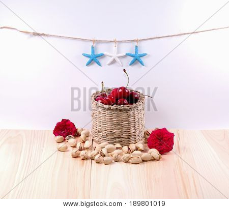 Cherries with flower starfish and white background.