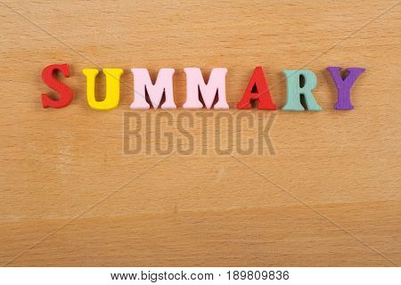 SUMMARY word on wooden background composed from colorful abc alphabet block wooden letters, copy space for ad text. Learning english concept