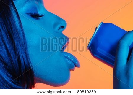 sensual african american girl drinking from can with loll out