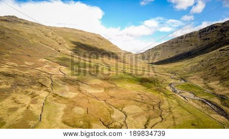 Wrynose Pass, English Lake District, Cumbria. Aerial drone image of the landscape of the English Lake District along the Wrynose Pass looking towards Harter Fell.