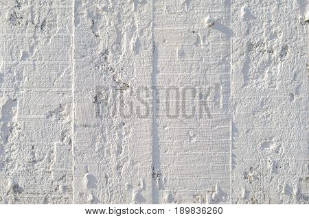 Texture of wooden formwork stamped on a raw concrete wall as background. Vertical strips from formwork