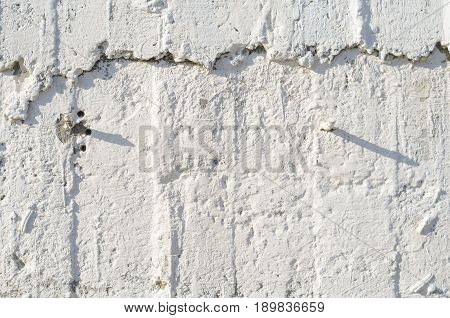 Texture of wooden formwork stamped on a raw concrete wall as background. Vertical strips from formwork