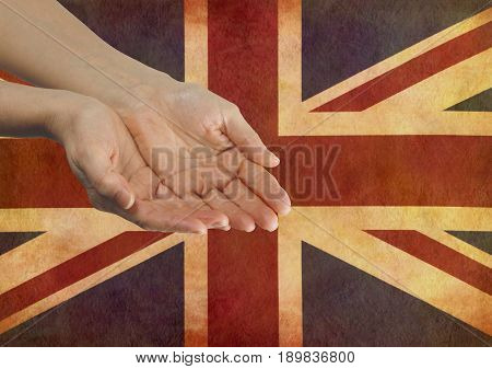 Give your Country your Support  - Female hands in open gesture against a rustic parchment Union Jack Flag with copy space