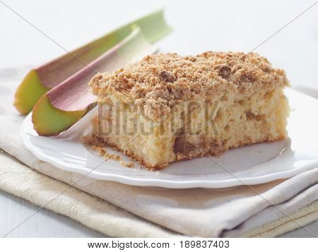 Piece of coffeecake isolated on white. Biscuit with strawberry, rhubarb and apples. Homemade crumble pie with streusel topping. Isolated. Selective focus.