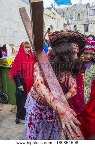 JERUSALEM - APRIL 14 : Christian pilgrims re-enact the crucifixtion of Jesus along the Via Dolorosa in Jerusalem during Good friday on April 14 2017