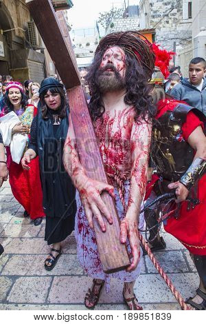 JERUSALEM - APRIL 14 : Christian pilgrims re-enact the crucifixtion of Jesus along the Via Dolorosa in Jerusalem during Good friday on April 14 2017