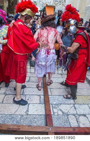JERUSALEM - APRIL 14 : Christian pilgrims re-enact the crucifixtion of Jesus along the Via Dolorosa in Jerusalem during Good friday on April 14 2017