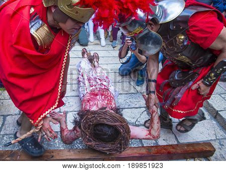 JERUSALEM - APRIL 14 : Christian pilgrims re-enact the crucifixtion of Jesus along the Via Dolorosa in Jerusalem during Good friday on April 14 2017