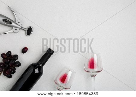Bottle of red wine with glasses on white background. Mock-up. Top view with copy space. Flat lay