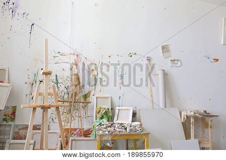 White wall stained with oil paint in the artist's studio interior workshop